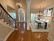 Open foyer features a curved staircase, chandelier lighting, and dining area for an inviting entrance at 1316 Plunket Dr, Wake Forest, NC 27587