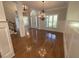 An open foyer with hardwood flooring, chandelier lighting, and decorative moulding creates a welcoming atmosphere at 1316 Plunket Dr, Wake Forest, NC 27587