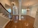 Open foyer features a curved staircase, chandelier lighting, and dining area for an inviting entrance at 1316 Plunket Dr, Wake Forest, NC 27587