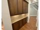 Hallway featuring custom cabinetry, granite countertops, and hardwood floors at 1316 Plunket Dr, Wake Forest, NC 27587