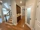 Hallway with hardwood floors, custom cabinetry, and staircase at 1316 Plunket Dr, Wake Forest, NC 27587