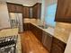 Kitchen with stainless steel appliances, granite countertops, hardwood floors, and modern fixtures at 1316 Plunket Dr, Wake Forest, NC 27587