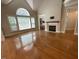 Bright living room showcasing large arched window, fireplace, and hardwood flooring for comfortable living at 1316 Plunket Dr, Wake Forest, NC 27587