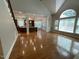 Spacious living area with hardwood floors, large windows, and open floor plan leading into the kitchen at 1316 Plunket Dr, Wake Forest, NC 27587