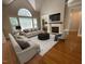 Inviting living room boasts vaulted ceilings, a fireplace, comfortable seating, and abundant natural light at 1316 Plunket Dr, Wake Forest, NC 27587