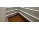Bright pantry featuring white shelving for organization and hardwood floors at 1316 Plunket Dr, Wake Forest, NC 27587