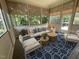Cozy screened porch featuring stylish seating, a patterned rug, and serene outdoor views through screened windows at 1316 Plunket Dr, Wake Forest, NC 27587