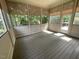Enclosed sunroom offers outdoor views and natural light through multiple windows with neutral colored roller shades at 1316 Plunket Dr, Wake Forest, NC 27587