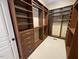 Spacious walk-in closet with custom wood shelving and drawers for maximum storage at 1316 Plunket Dr, Wake Forest, NC 27587