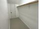 A walk-in closet with hanging rods and a door for privacy and organization at 1316 Plunket Dr, Wake Forest, NC 27587