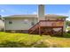 Home exterior featuring a wood deck and lush green backyard at 1401 Burchcrest Dr, Garner, NC 27529
