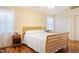 Bedroom featuring hardwood floors, a wooden bed, and natural light from multiple windows at 1401 Burchcrest Dr, Garner, NC 27529