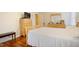 View of a bedroom with a wooden bed frame, hardwood floors, and ample closet space at 1401 Burchcrest Dr, Garner, NC 27529