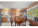 Dining area with wood table and chairs, tile flooring, and cabinets to store items at 1401 Burchcrest Dr, Garner, NC 27529