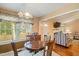 Dining area with wood table and chairs, tile floor and a view into the cozy living room at 1401 Burchcrest Dr, Garner, NC 27529