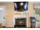 Living room with a fireplace, hardwood floors, and plenty of natural light through the window at 1401 Burchcrest Dr, Garner, NC 27529