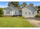 Charming single-story home with light siding, a well-manicured lawn, and mature trees at 1401 Burchcrest Dr, Garner, NC 27529