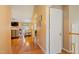 Open hallway with hardwood floors, neutral walls leading to a cozy living room with fireplace at 1401 Burchcrest Dr, Garner, NC 27529