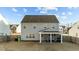 Backyard view of a two-story home with a screened in porch and fenced in yard at 158 Arlie Ln, Lillington, NC 27546