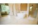 Bright bathroom with tub, glass shower, and natural light with views of trees at 1620 Hunting Ridge Rd, Raleigh, NC 27615