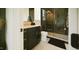 Stylish bathroom with dark cabinetry, marble countertop, and glass shower, creating a spa-like experience at 1620 Hunting Ridge Rd, Raleigh, NC 27615