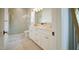 Modern bathroom featuring a glass-enclosed shower, double vanity, and elegant fixtures, showcasing refined design at 1620 Hunting Ridge Rd, Raleigh, NC 27615
