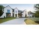 Stunning white brick home with dark trim, manicured lawn, and circular driveway at 1620 Hunting Ridge Rd, Raleigh, NC 27615