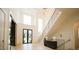 Bright foyer with grand staircase, hardwood floors, and elegant lighting fixtures at 1620 Hunting Ridge Rd, Raleigh, NC 27615
