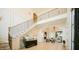 Elegant foyer with staircase, hardwood floors, chandelier, and open view to living area at 1620 Hunting Ridge Rd, Raleigh, NC 27615