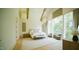 Bright main bedroom with vaulted ceilings, large windows, and comfortable seating area at 1620 Hunting Ridge Rd, Raleigh, NC 27615