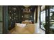 Modern office with built-in shelving, stylish light fixture, and plush armchairs at 1620 Hunting Ridge Rd, Raleigh, NC 27615