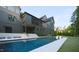 Backyard with a swimming pool, a patio, and landscaped greenery, perfect for outdoor relaxation at 1620 Hunting Ridge Rd, Raleigh, NC 27615