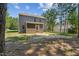 View of backyard with a spacious lawn, mature trees, and screened-in porch, offering a private outdoor space at 170 Lothian, Rocky Mount, NC 27804