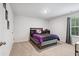 This secondary bedroom features neutral walls, carpet flooring, and a bright window at 170 Lothian, Rocky Mount, NC 27804