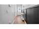 Well-lit hallway featuring wood floors, decorative wainscoting, and multiple doorways at 170 Lothian, Rocky Mount, NC 27804