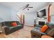 Cozy living room features plush sofas, a fireplace, and a ceiling fan for year-round comfort at 170 Lothian, Rocky Mount, NC 27804
