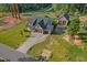 Expansive aerial view showcases the home's landscaping, with a detached garage and private driveway at 178 Greenwich Dr, Sanford, NC 27330