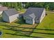 Aerial view of fenced backyard featuring a detached garage, well-maintained lawn perfect for outdoor activities and relaxation at 178 Greenwich Dr, Sanford, NC 27330