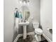Stylish powder room featuring a pedestal sink, decorative lighting, and modern fixtures for a sophisticated touch at 178 Greenwich Dr, Sanford, NC 27330