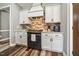 Well-equipped kitchen features white cabinets, black appliances, and granite countertops at 178 Greenwich Dr, Sanford, NC 27330