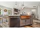 Stylish kitchen island featuring a copper sink, granite countertop, and wood floors at 178 Greenwich Dr, Sanford, NC 27330
