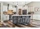 Modern kitchen boasts white cabinets, stainless appliances, and a large center island at 178 Greenwich Dr, Sanford, NC 27330