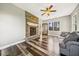 Living room featuring fireplace with stone surround, ceiling fan and wood flooring at 178 Greenwich Dr, Sanford, NC 27330