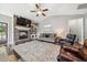Cozy living room with brick fireplace, wood floors, and a large, decorative rug at 178 Greenwich Dr, Sanford, NC 27330