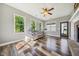 Living room with many windows, a ceiling fan, wood flooring and gray walls at 178 Greenwich Dr, Sanford, NC 27330