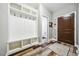 Bright mudroom featuring a built-in storage bench, coat hooks, and durable wood-look floors for an organized transition space at 178 Greenwich Dr, Sanford, NC 27330