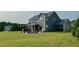 Spacious backyard with patio, hot tub, outdoor seating, and lush lawn at 192 Waterpine Dr, Garner, NC 27529