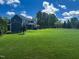 Expansive backyard with lush greenery, outdoor entertaining space, and a private feel at 192 Waterpine Dr, Garner, NC 27529
