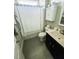 Bathroom with a shower-tub combo and dark wood vanity at 192 Waterpine Dr, Garner, NC 27529