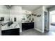Bathroom featuring double vanities, decorative shelves, a large mirror, and tile floors at 192 Waterpine Dr, Garner, NC 27529